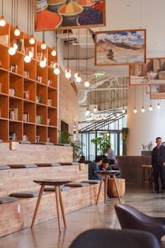 Elegant modern workspace in Singapore with bookshelves and pendant lighting.